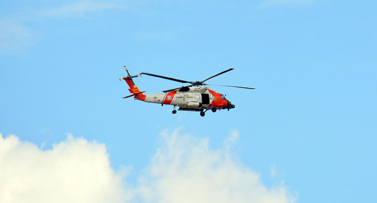 A USCG helicopter flying above U.S. Coast Guard Air Station Elizabeth City
